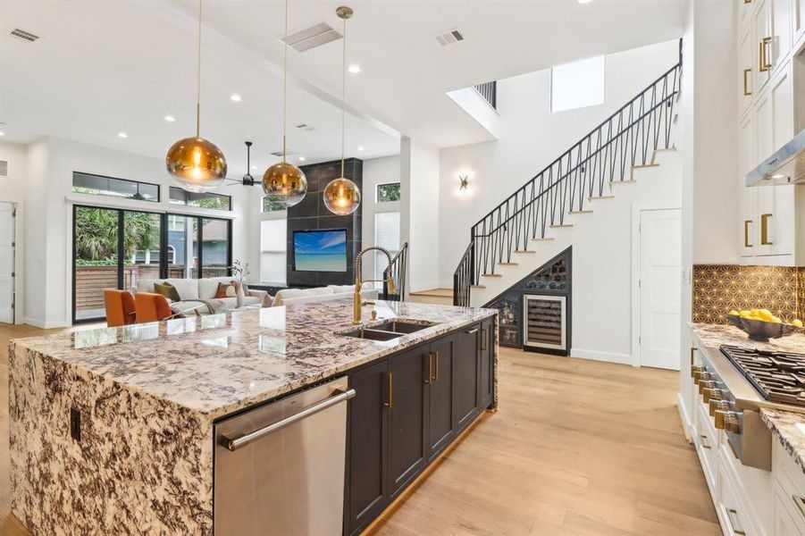 Amazingly appointed kitchen looking into the wine and liquor storage nook under the stairs.