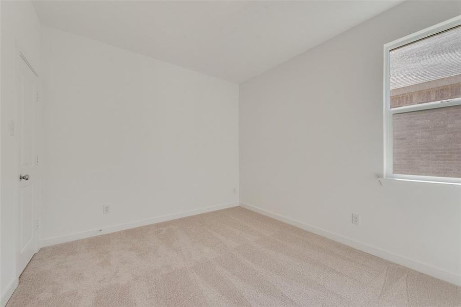 Empty room with light colored carpet