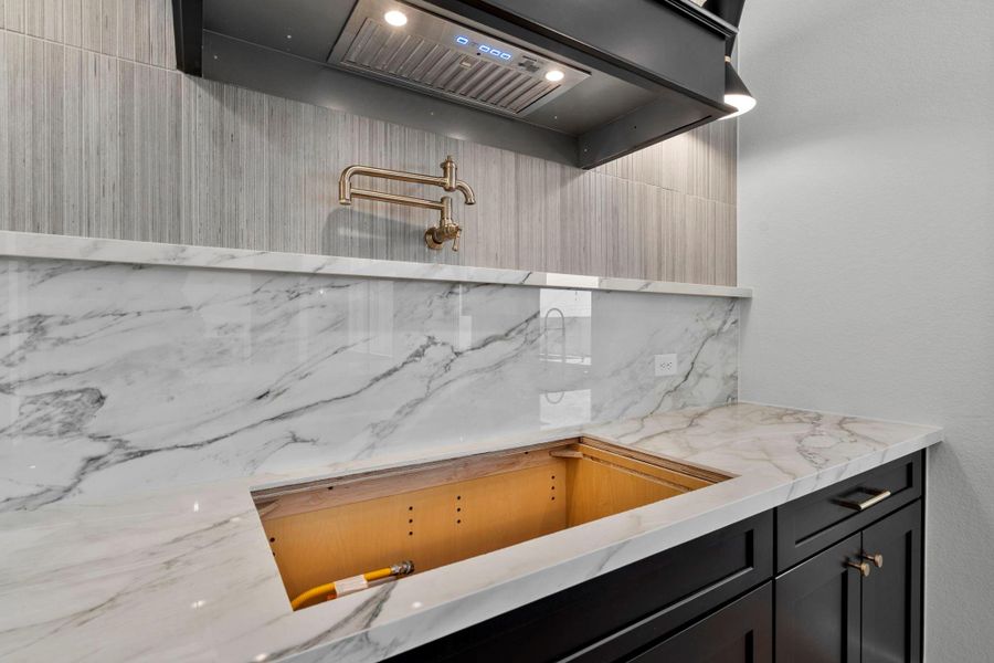 Stovetop area with porcelain counters and backsplash.