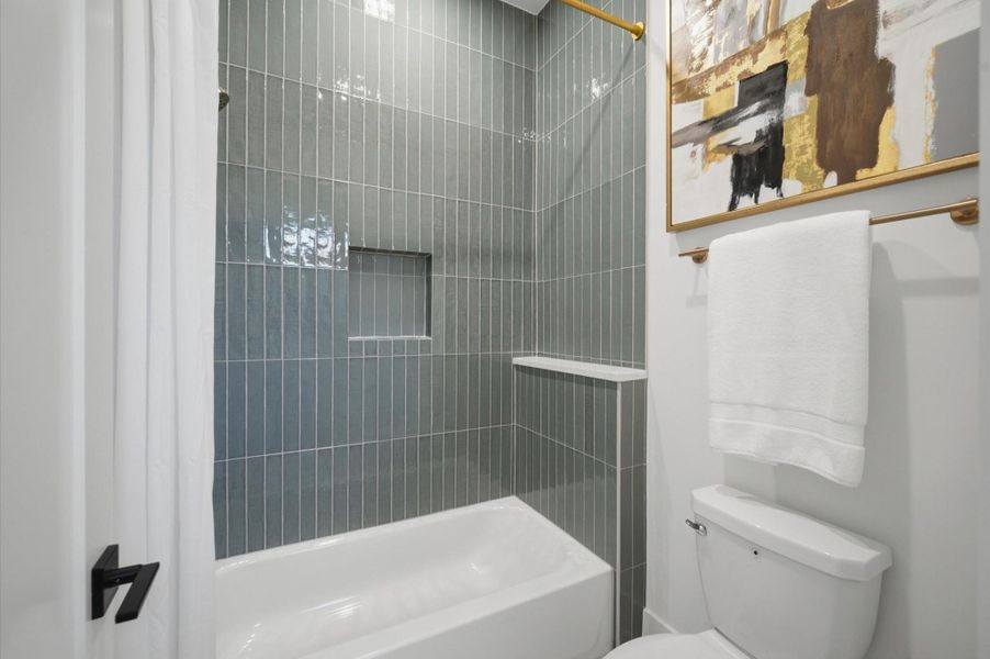 Shared full bath with direct access from bedroom and game room.