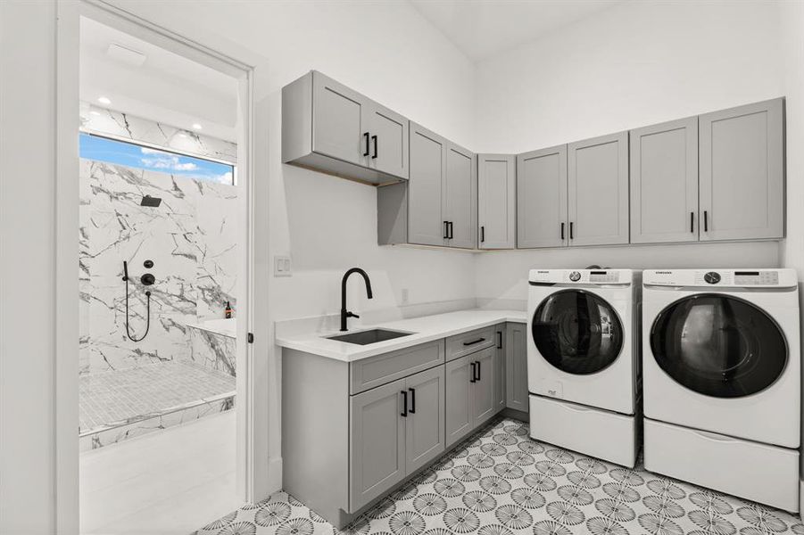 Even the utility room is incredible! Stunning tile flooring, quartz countertop with utility sink and storage cabinets make laundry day a breeze. It is also conveniently connected to the Primary Bathroom!