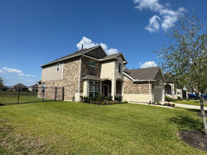Front exterior of a new home in Rodeo Palms - The Lakes, Manvel, TX, highlighting curb appeal (Image 2). Front exterior of a new home in Rodeo Palms - The Lakes, Manvel, TX, highlighting curb appeal (Image 2).