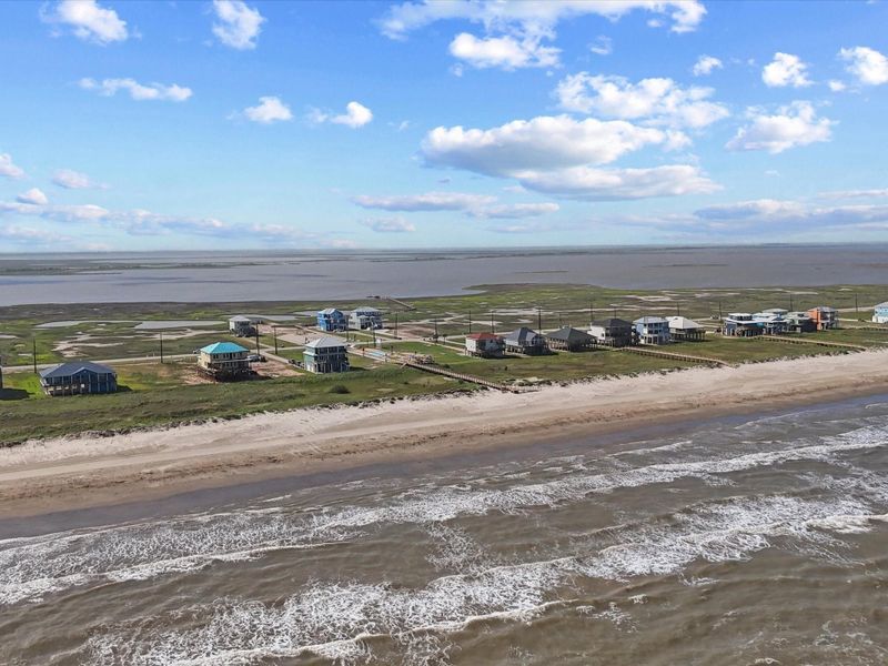 This wide aerial reveals the true scope of your future view. With no houses between you and the water, 5002 Blue Water Hwy offers a rare, unobstructed slice of beachfront paradise—on one of the few stable beaches remaining along the Texas Gulf Coast.