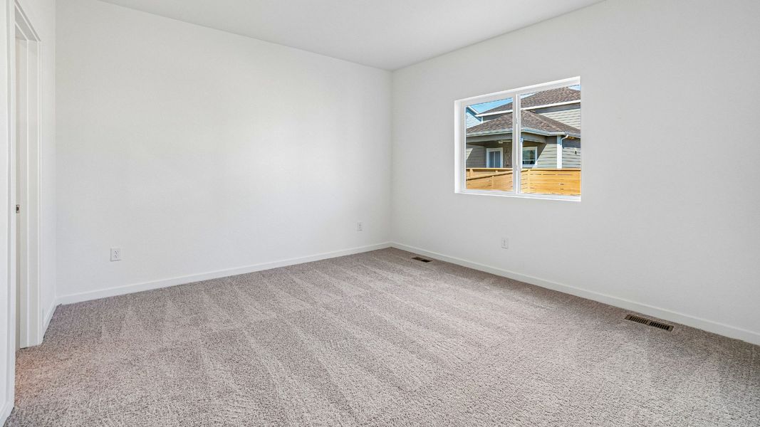A welcoming primary bedroom designed for rest and relaxation