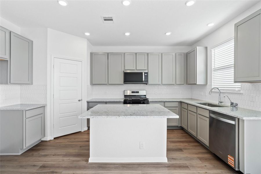 This kitchen provides a clear view into the adjacent dining nook, creating a cohesive space for cooking and gathering.