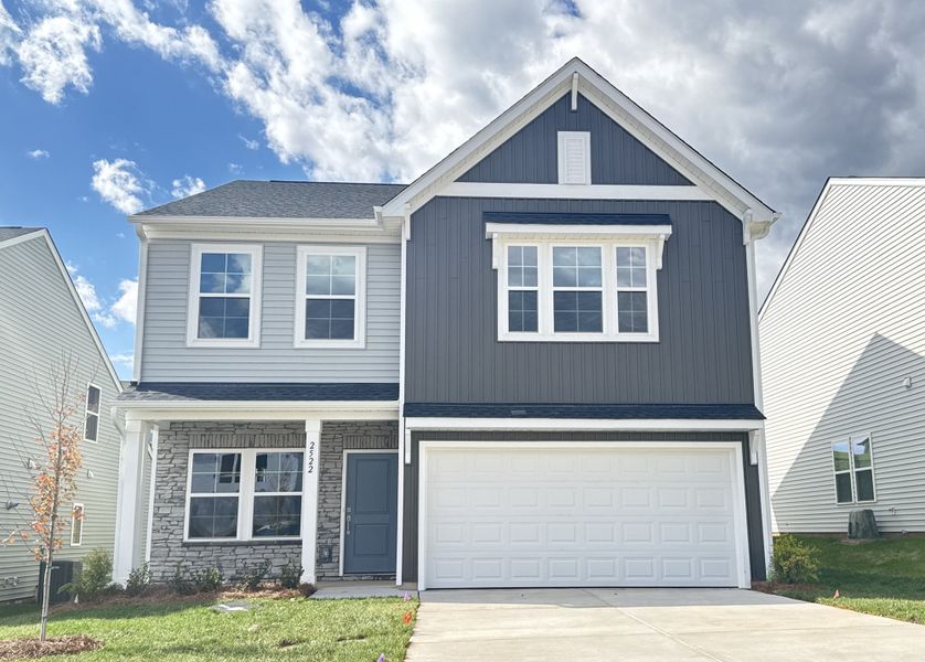 Front exterior of a new home in Hanes Lake, Winston-Salem, NC, highlighting curb appeal (Image 1). Front exterior of a new home in Hanes Lake, Winston-Salem, NC, highlighting curb appeal (Image 1).