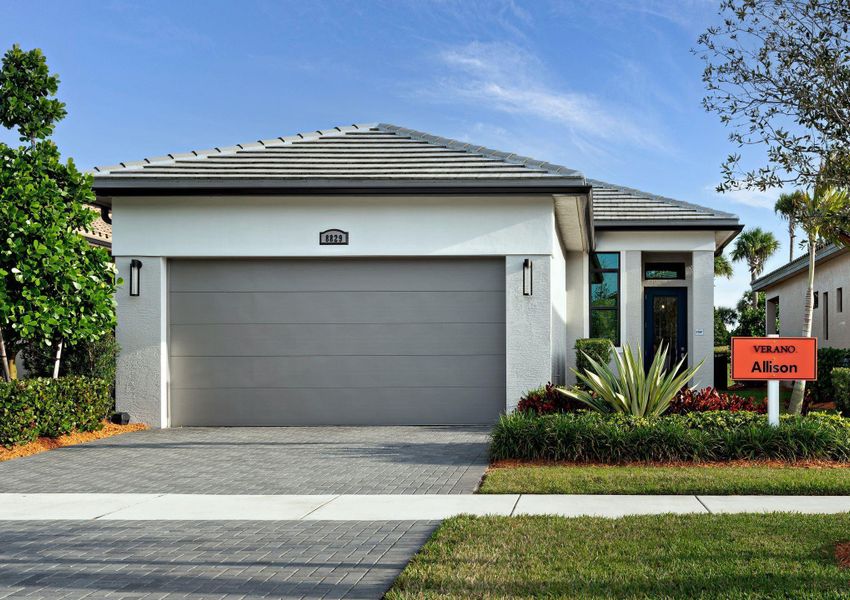 Front exterior of a new home in PGA Village Verano, Port St. Lucie, FL, highlighting curb appeal (Image 1).