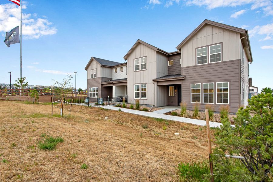 Front exterior of a new home in Candelas Townhomes, Arvada, CO, highlighting curb appeal (Image 2). Front exterior of a new home in Candelas Townhomes, Arvada, CO, highlighting curb appeal (Image 2).