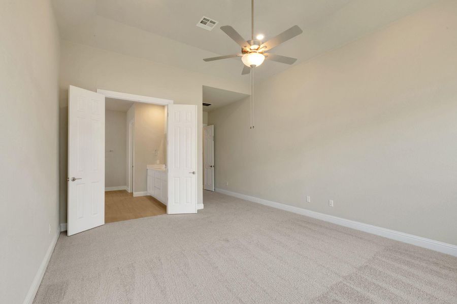 Unfurnished bedroom with visible vents, baseboards, and light colored carpet Unfurnished bedroom with visible vents, baseboards, and light colored carpet