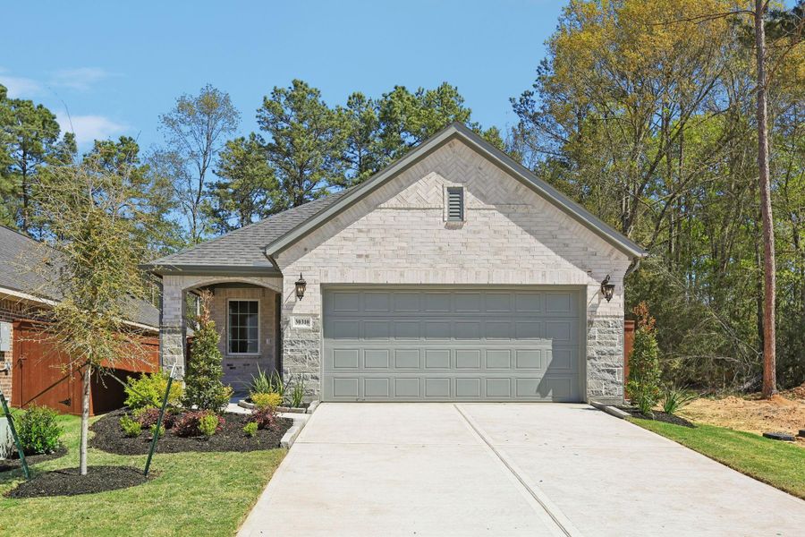 Front exterior of a new home in Woodhavyn 40', Magnolia, TX, highlighting curb appeal (Image 18).