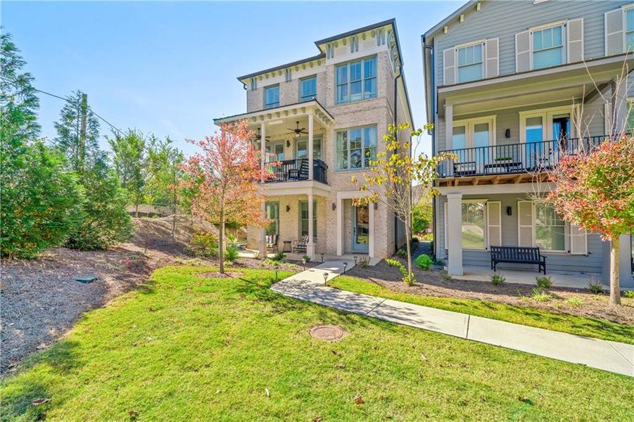 View of front of property featuring a porch, a front lawn, and a balcony View of front of property featuring a porch, a front lawn, and a balcony