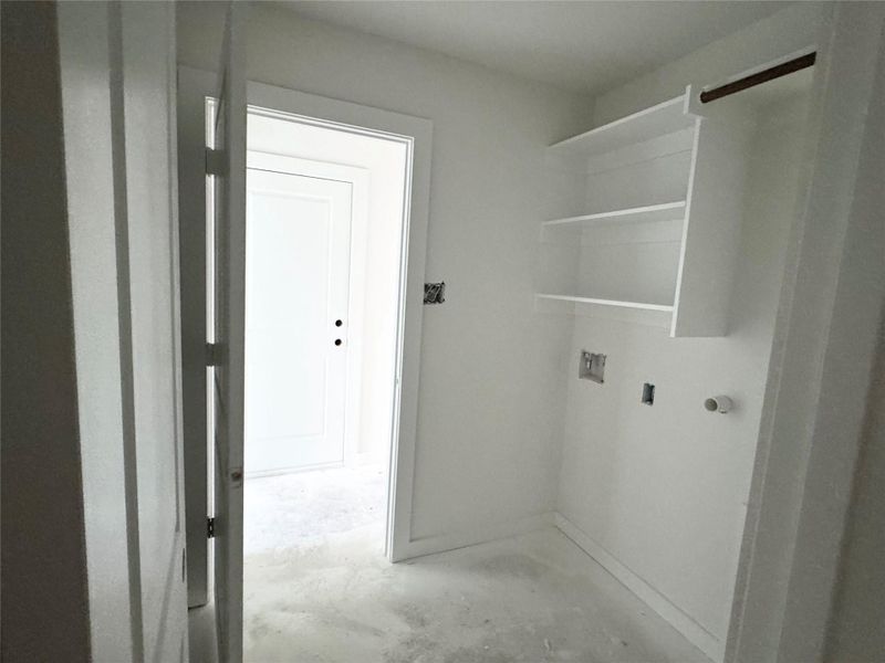 Washroom featuring unfinished concrete flooring and hookup for a washing machine