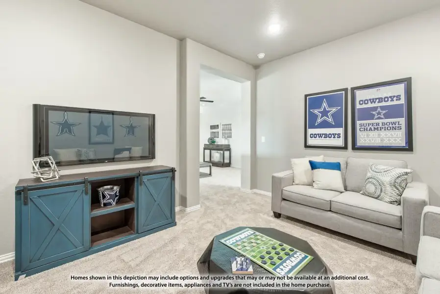 Living room with gray sofa, wall-mounted TV, blue barn-door media console, and Cowboys sports decor on carpet Living room with gray sofa, wall-mounted TV, blue barn-door media console, and Cowboys sports decor on carpet