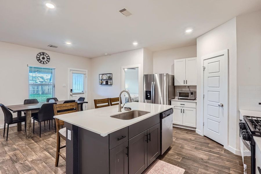 Kitchen featuring a sink, visible vents, white cabinetry, and stainless steel appliances