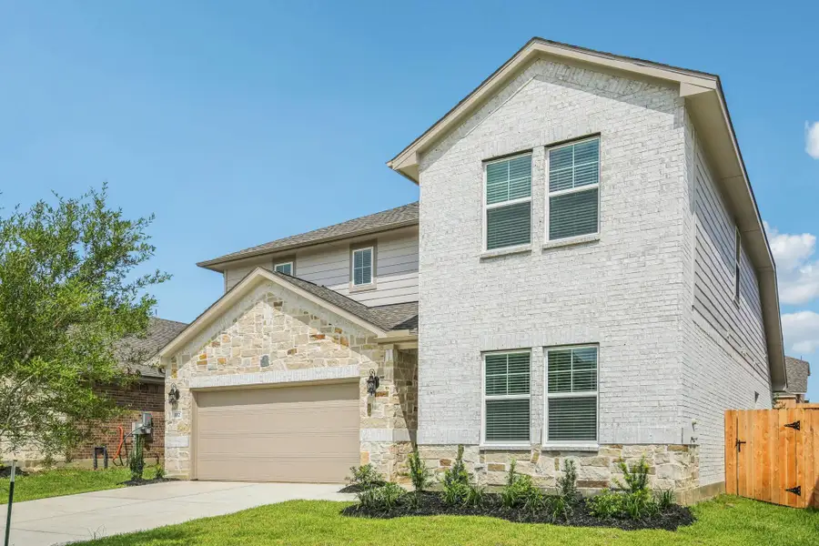 Front exterior of a new home in Pine Lake Cove - Classic Series, Montgomery, TX, highlighting curb appeal (Image 10). Front exterior of a new home in Pine Lake Cove - Classic Series, Montgomery, TX, highlighting curb appeal (Image 10).
