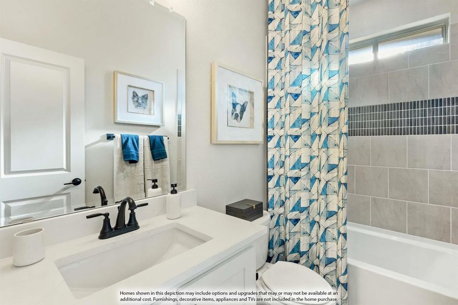 Bathroom with white vanity, black faucet, tub with blue geometric shower curtain, and gray tile surround Bathroom with white vanity, black faucet, tub with blue geometric shower curtain, and gray tile surround