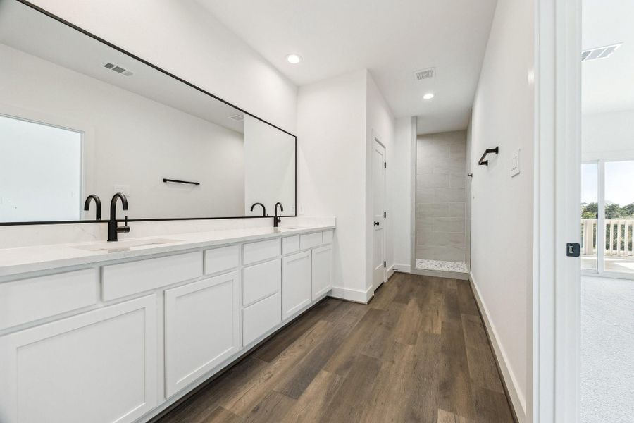 Your primary bathroom oasis features dual sinks, plenty of countertop space and quartz counter tops. Your primary bathroom oasis features dual sinks, plenty of countertop space and quartz counter tops.