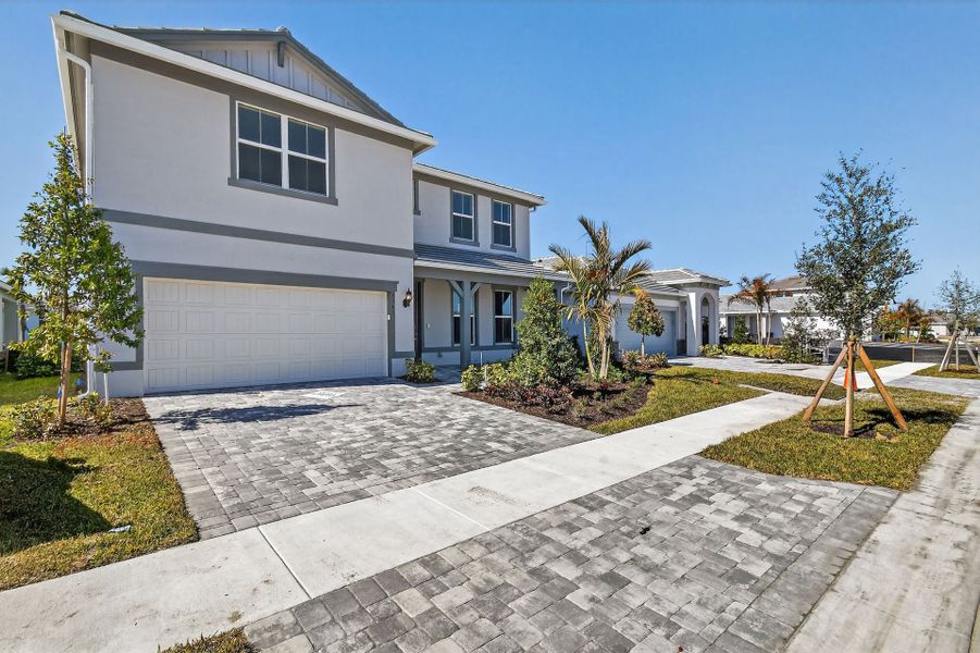 Front exterior of a new home in Harbor Isle, Vero Beach, FL, highlighting curb appeal (Image 27). Front exterior of a new home in Harbor Isle, Vero Beach, FL, highlighting curb appeal (Image 27).