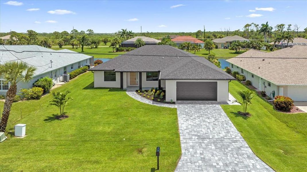 Front exterior of a new home in , Rotonda West, FL, highlighting curb appeal (Image 1).