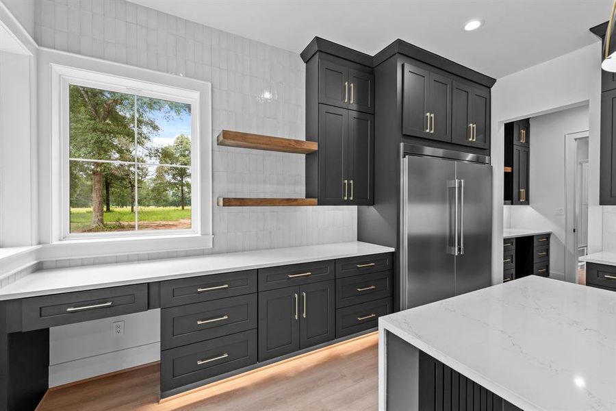 Tile backsplash to the ceiling with floating shelves.