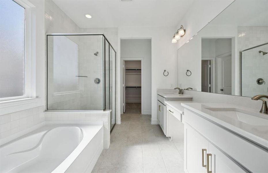 Owner's bath designed with a double vanity and oversized tub