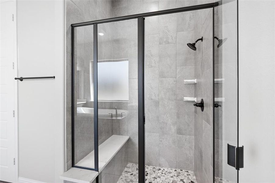 Bathroom featuring a shower stall and baseboards