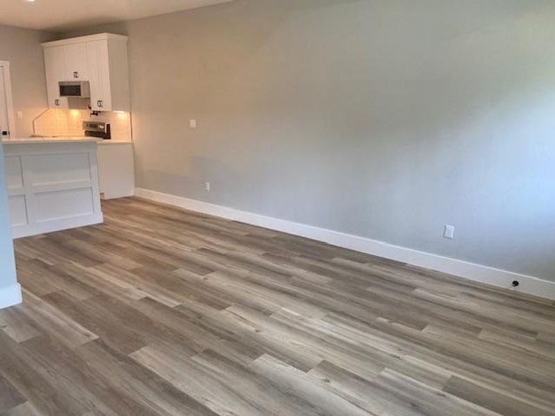 A harmonious open-concept living area boasts a modern kitchen with a convenient breakfast bar. A harmonious open-concept living area boasts a modern kitchen with a convenient breakfast bar.