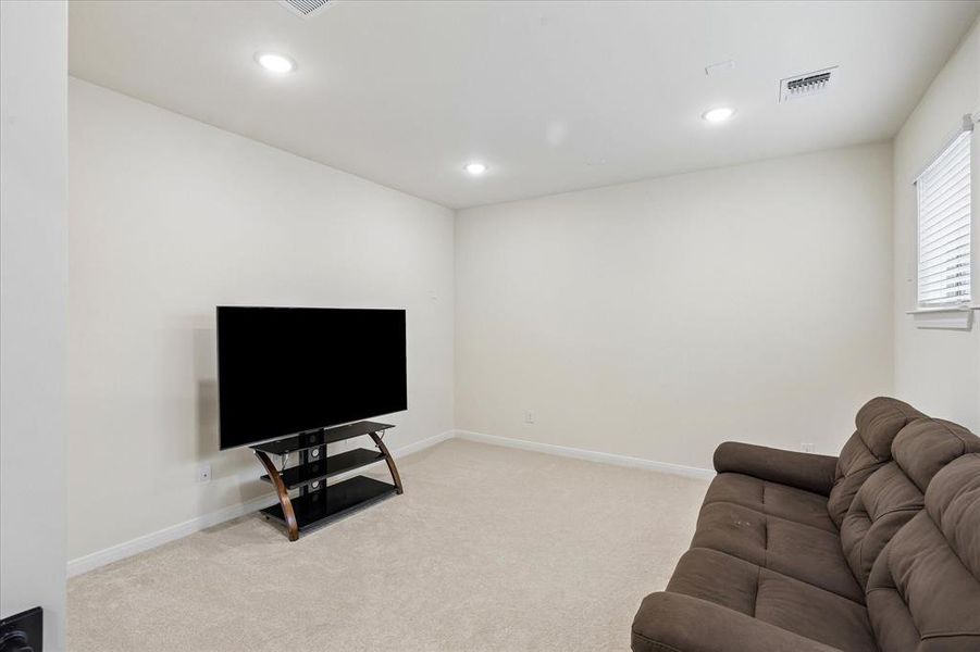 Recessed lighting illuminates the neutral wall tones and light-colored carpeting in this versatile space Recessed lighting illuminates the neutral wall tones and light-colored carpeting in this versatile space