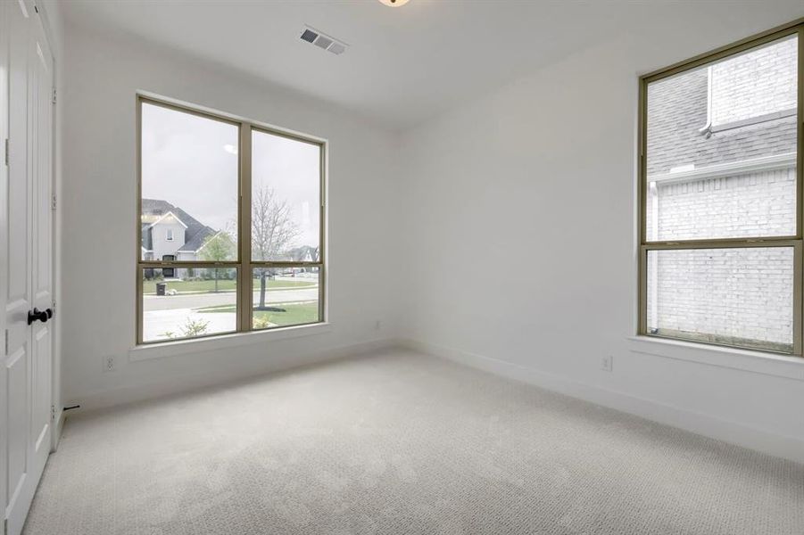 The room features light-colored carpeting, white walls, and white trim