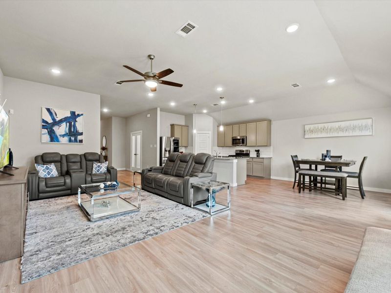 Spacious family room with vaulted ceiling and abundant natural light.