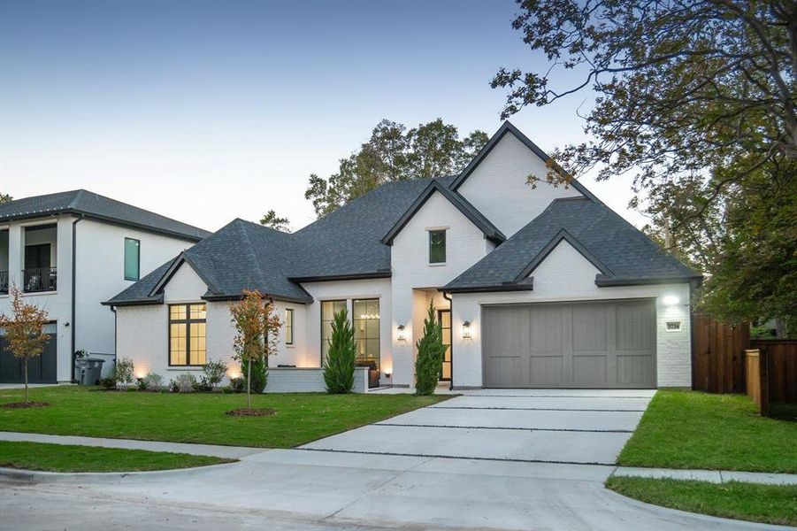 View of front of property featuring brick siding, driveway, roof with shingles, and an attached garage View of front of property featuring brick siding, driveway, roof with shingles, and an attached garage