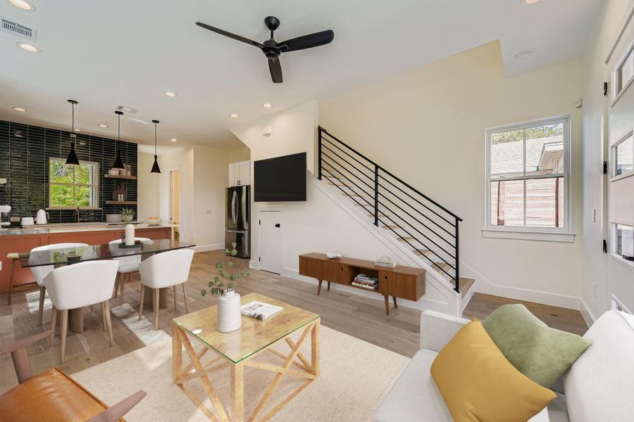 Living room featuring recessed lighting, light wood-style flooring, stairway, and a ceiling fan Living room featuring recessed lighting, light wood-style flooring, stairway, and a ceiling fan