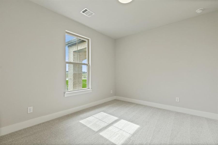 Carpeted empty room featuring plenty of natural light