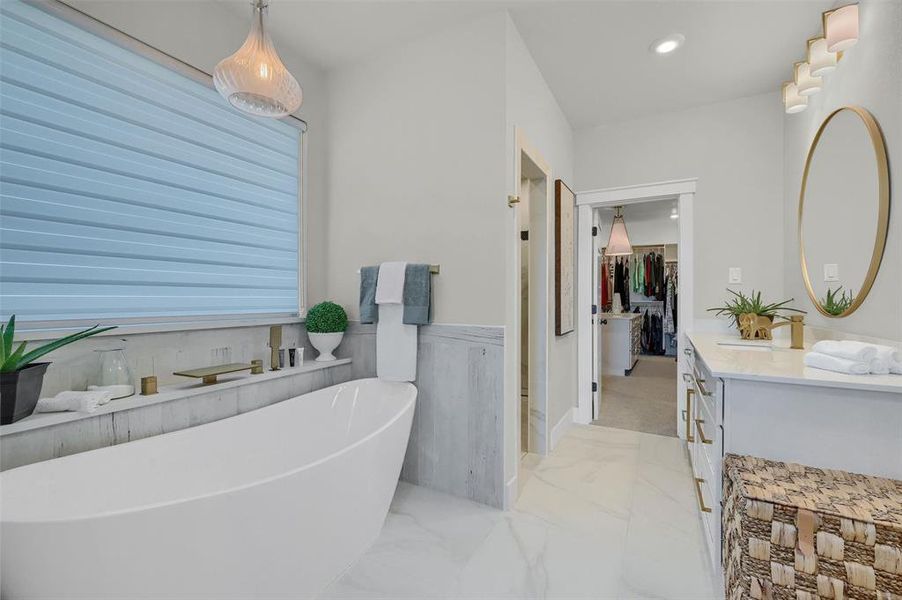 Bathroom with vanity and a washtub