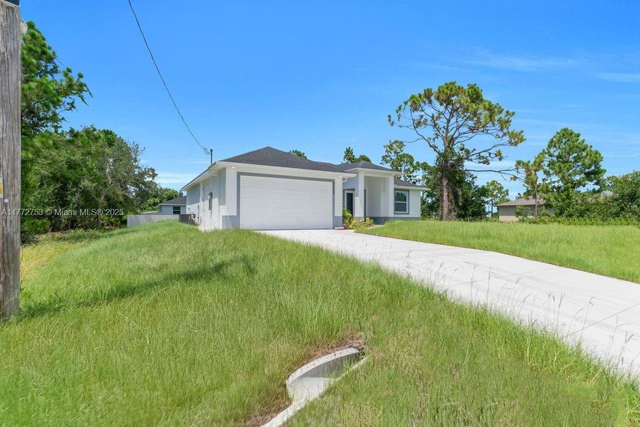 Front exterior of a new home in , Lehigh Acres, FL, highlighting curb appeal (Image 21).