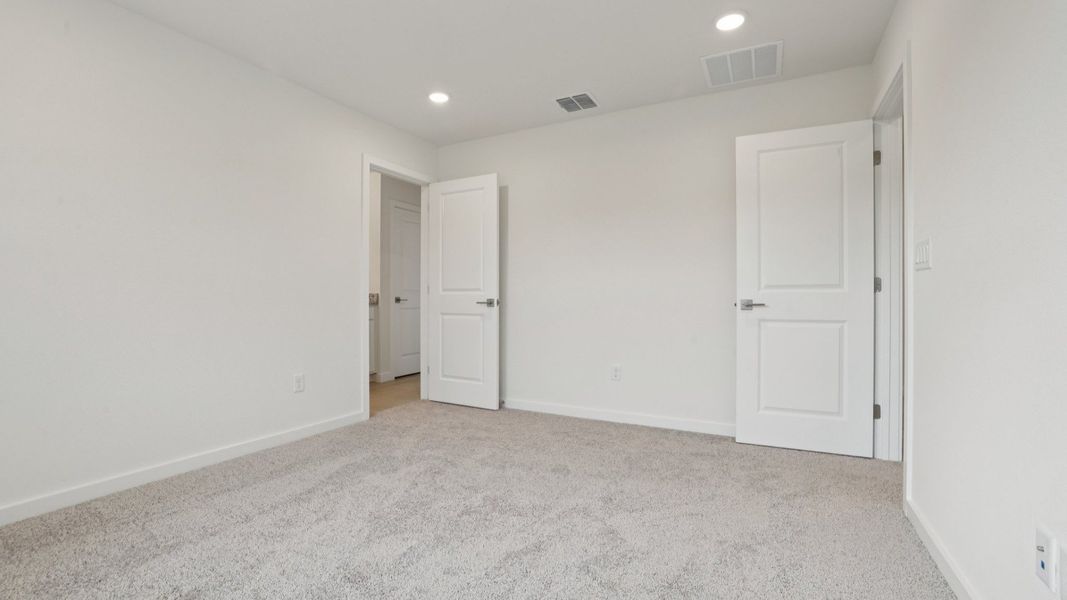 Primary suite with en suite Bath of the Coronado - End at Cyrene at Harmony located in St Cloud FL by DRB Homes