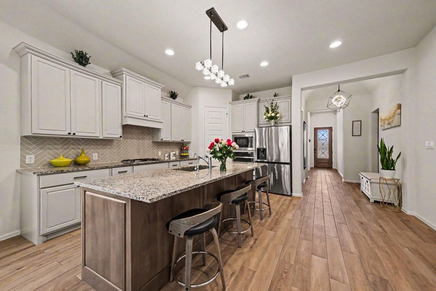 This impressive kitchen also has a farm-style sink, pots and pans drawers, and a walk-in pantry. This impressive kitchen also has a farm-style sink, pots and pans drawers, and a walk-in pantry.