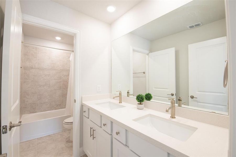 Designed for busy households, the upstairs full bath features dual sinks, abundant counter space, and a separate tub and shower area, making morning routines more efficient. Designed for busy households, the upstairs full bath features dual sinks, abundant counter space, and a separate tub and shower area, making morning routines more efficient.