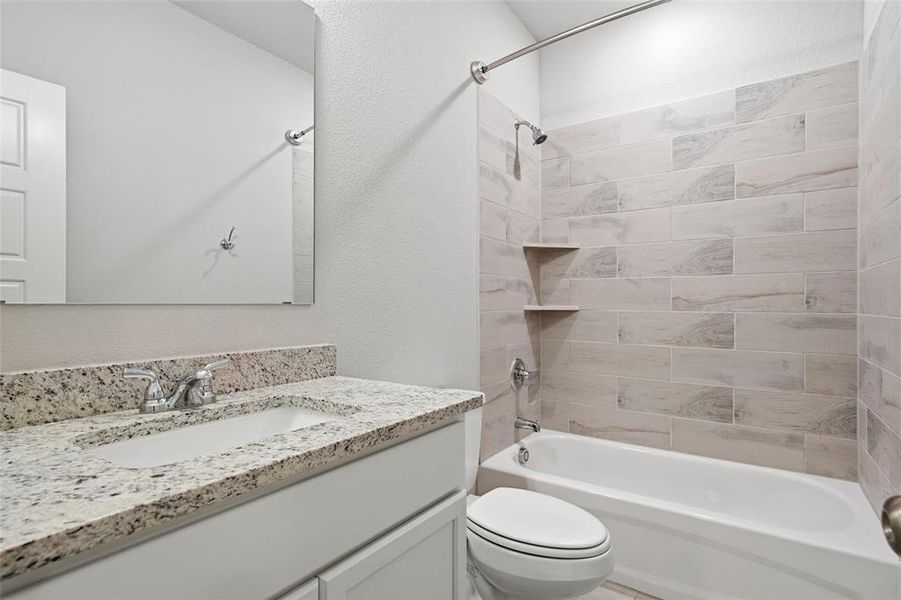Full bath with tub / shower combination, vanity, and a textured wall