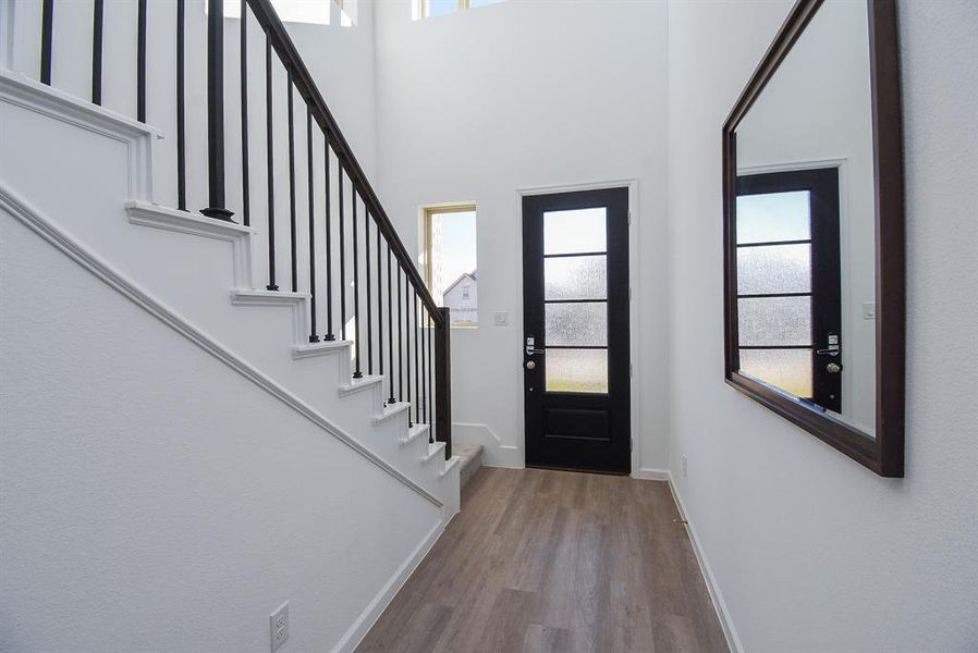 Cool walls and sleek contemporary structures fill this gorgeous front entry, from the inside.