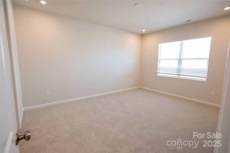 Primary Suite with large bright windows.