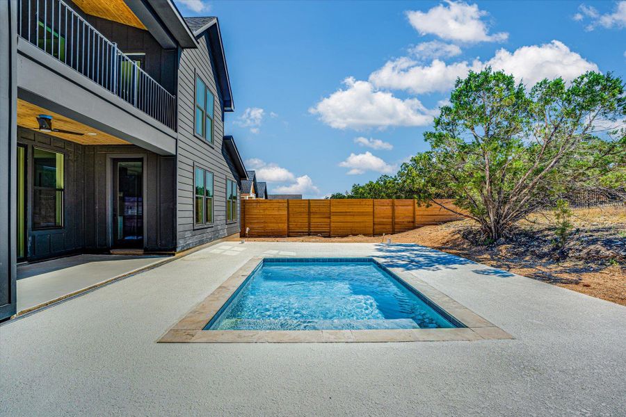 A private backyard oasis features a glistening inground pool, offering serene relaxation alongside the modern residence.