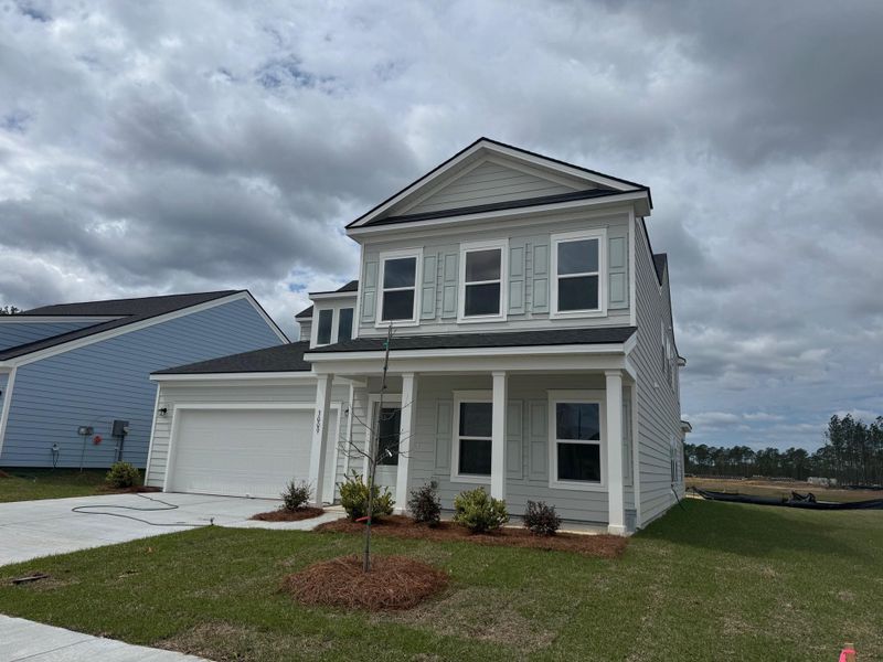 Front exterior of a new home in Tea Farm, Ravenel, SC, highlighting curb appeal (Image 24).