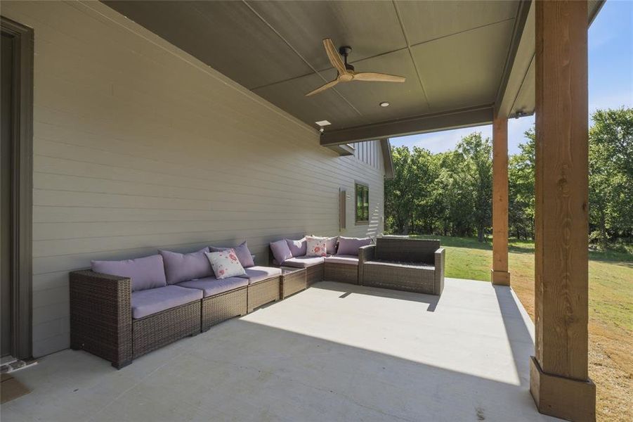 Spacious covered patio featuring a concrete surface, a ceiling fan, recessed lighting, and a substantial wood support column
