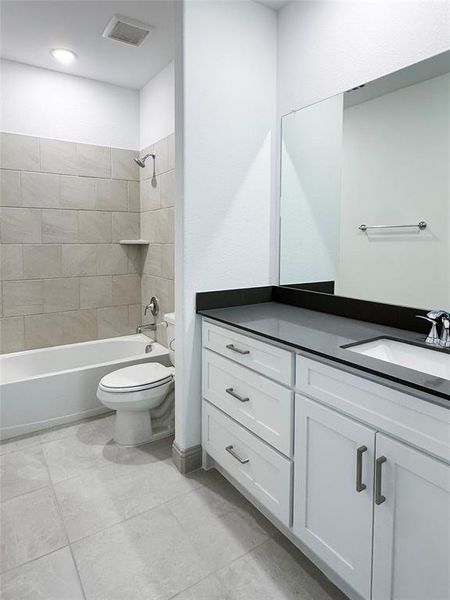 Full bathroom featuring visible vents, tub / shower combination, toilet, and vanity