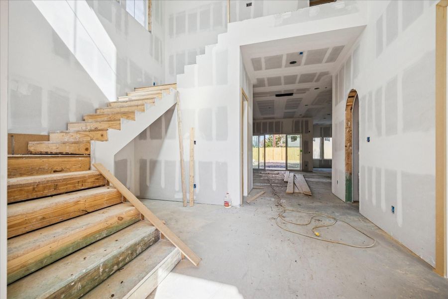 The main entry opens with a striking open staircase and generous ceiling height, creating a sense of volume and architectural presence from the moment you arrive. Clear sightlines extend toward the main living areas and backyard, while the layout allows for a statement wine wall with storage tucked beneath the stairs and seamless flow into the heart of the home. The main entry opens with a striking open staircase and generous ceiling height, creating a sense of volume and architectural presence from the moment you arrive. Clear sightlines extend toward the main living areas and backyard, while the layout allows for a statement wine wall with storage tucked beneath the stairs and seamless flow into the heart of the home.