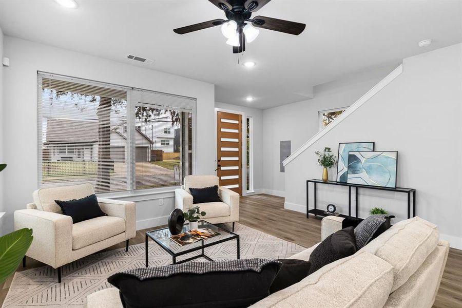 Living room with light wood-type flooring and ceiling fan