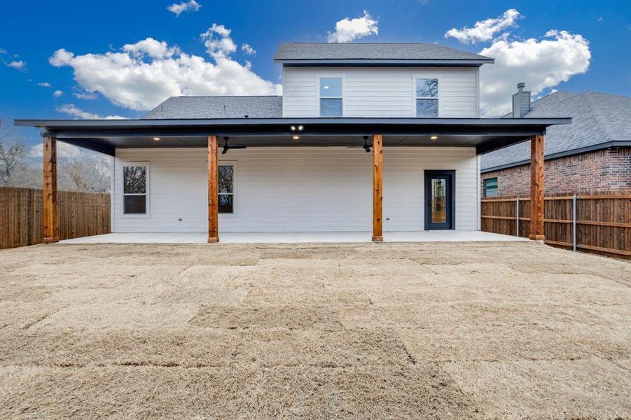 Back of house with a fenced backyard
