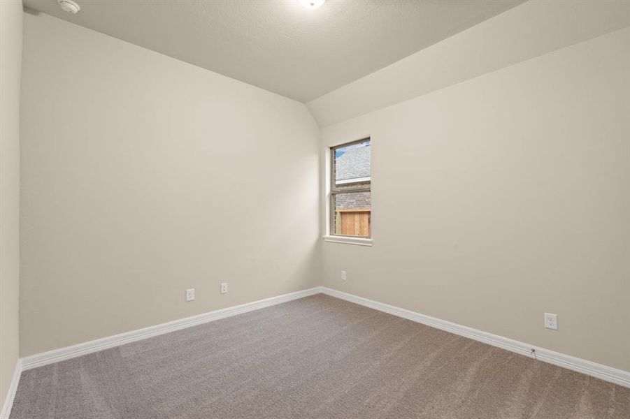 Your secondary bedroom features plush carpet, fresh paint, closet, and a large window that lets in plenty of natural lighting.