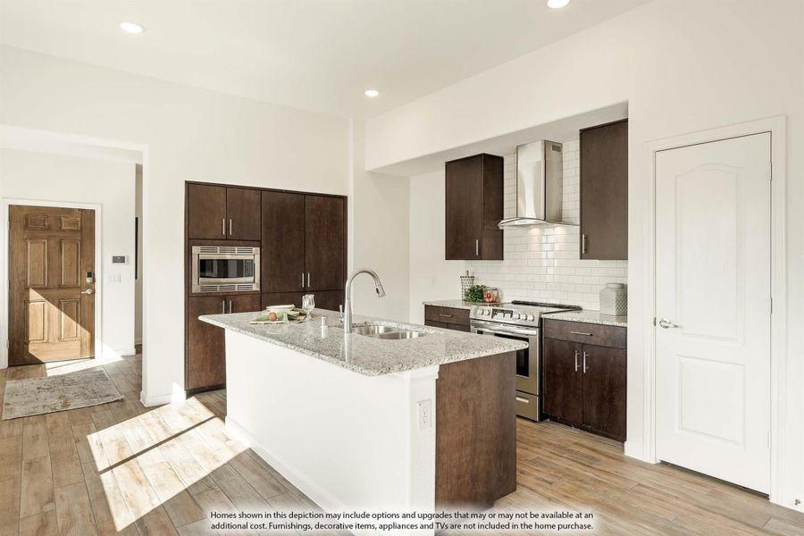 Kitchen with granite island, dark wood cabinets, stainless steel appliances, and subway tile backsplash on wood floors